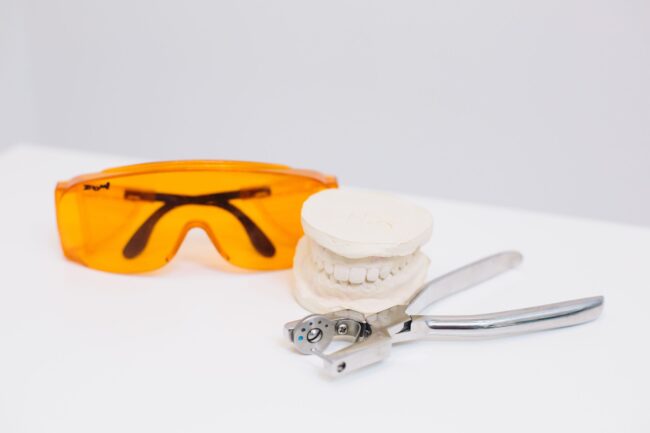 pexels-polina-zimmerman-4687403 Safety glasses, a dental model and extraction forceps prepared for after-hours dental pain in London, Ontario