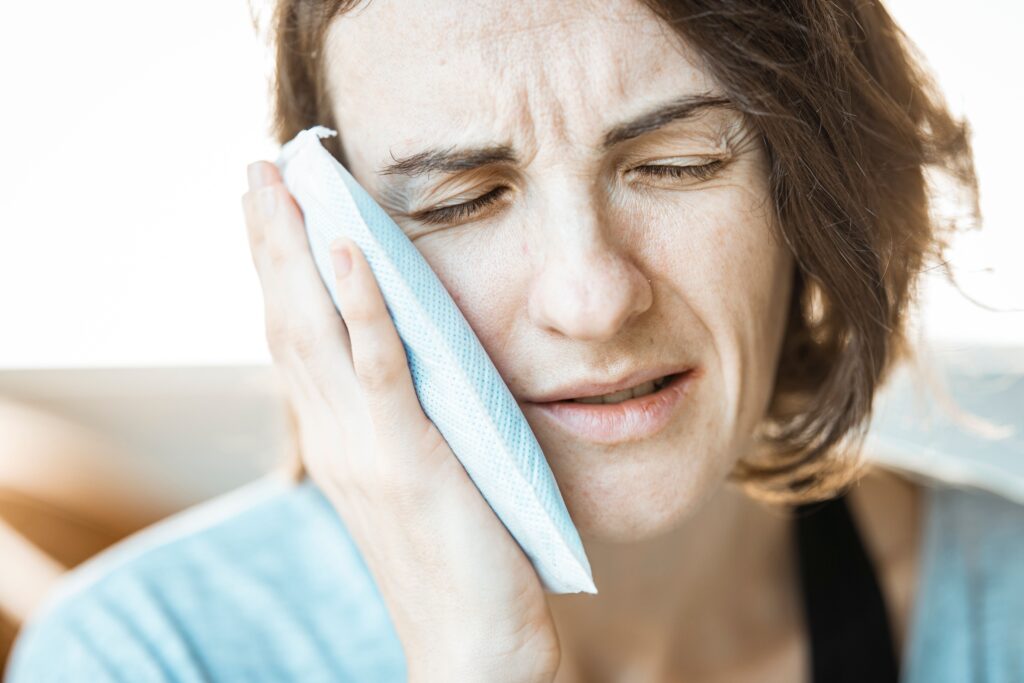 Dental Blog 183 Woman holding a cold compress while waiting to see an emergency dentist near me in London, Ontario